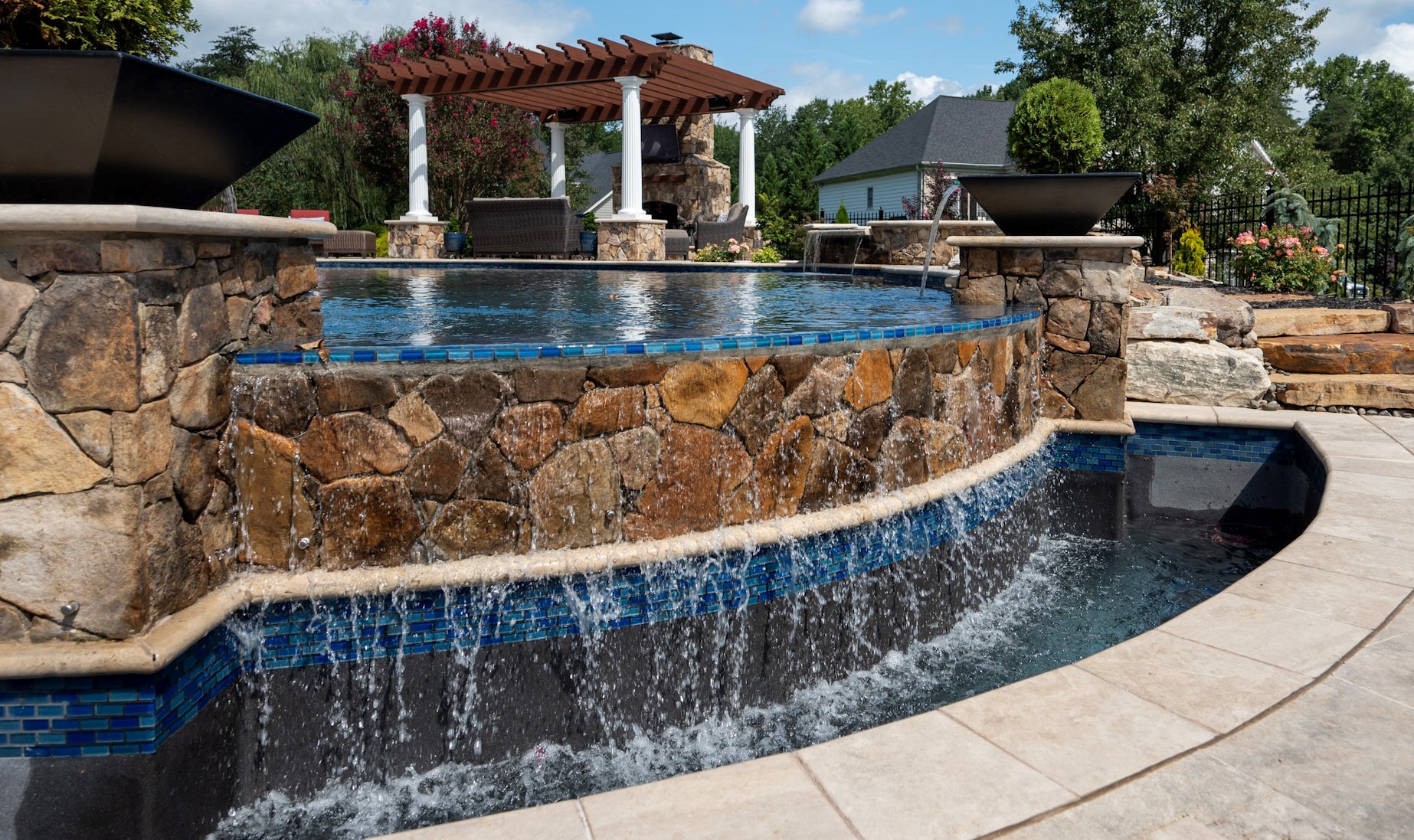 Stone waterfall feature on a custom pool